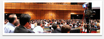 A large conference room filled with people in attendence