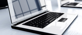 An image of a laptop on a desk to signify Real Time Electronic Communication